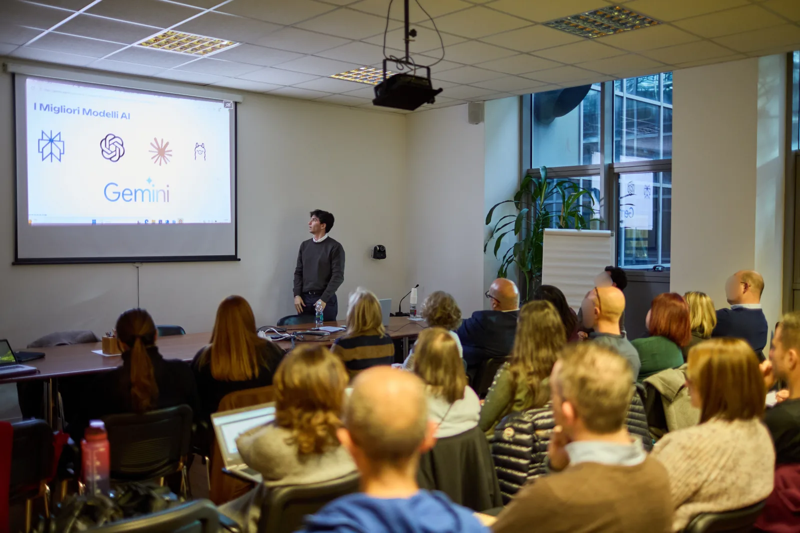 A full meeting room during a day of corporate AI training